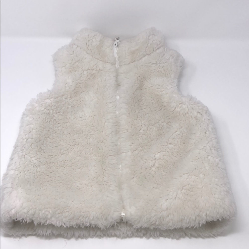Carter’s white faux fur vest.